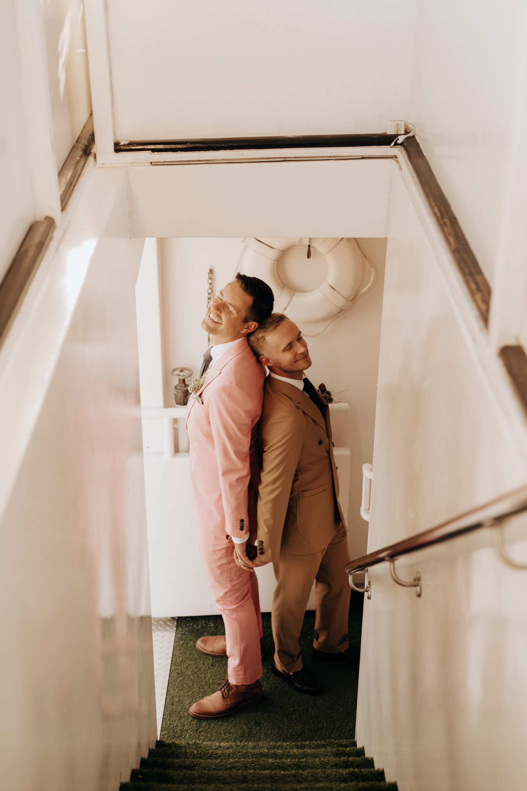 two grooms getting married on a boat