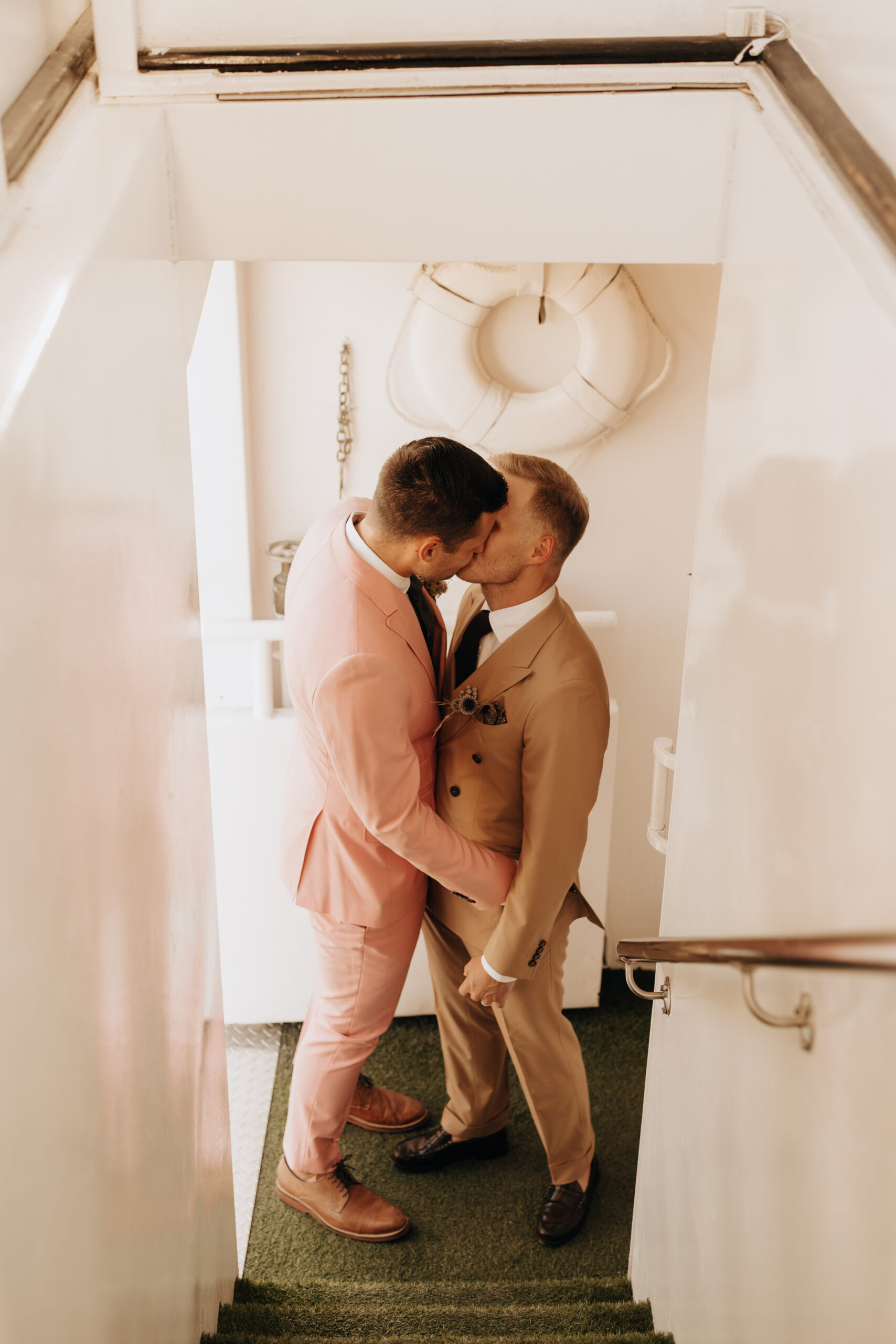 two grooms getting married on a boat