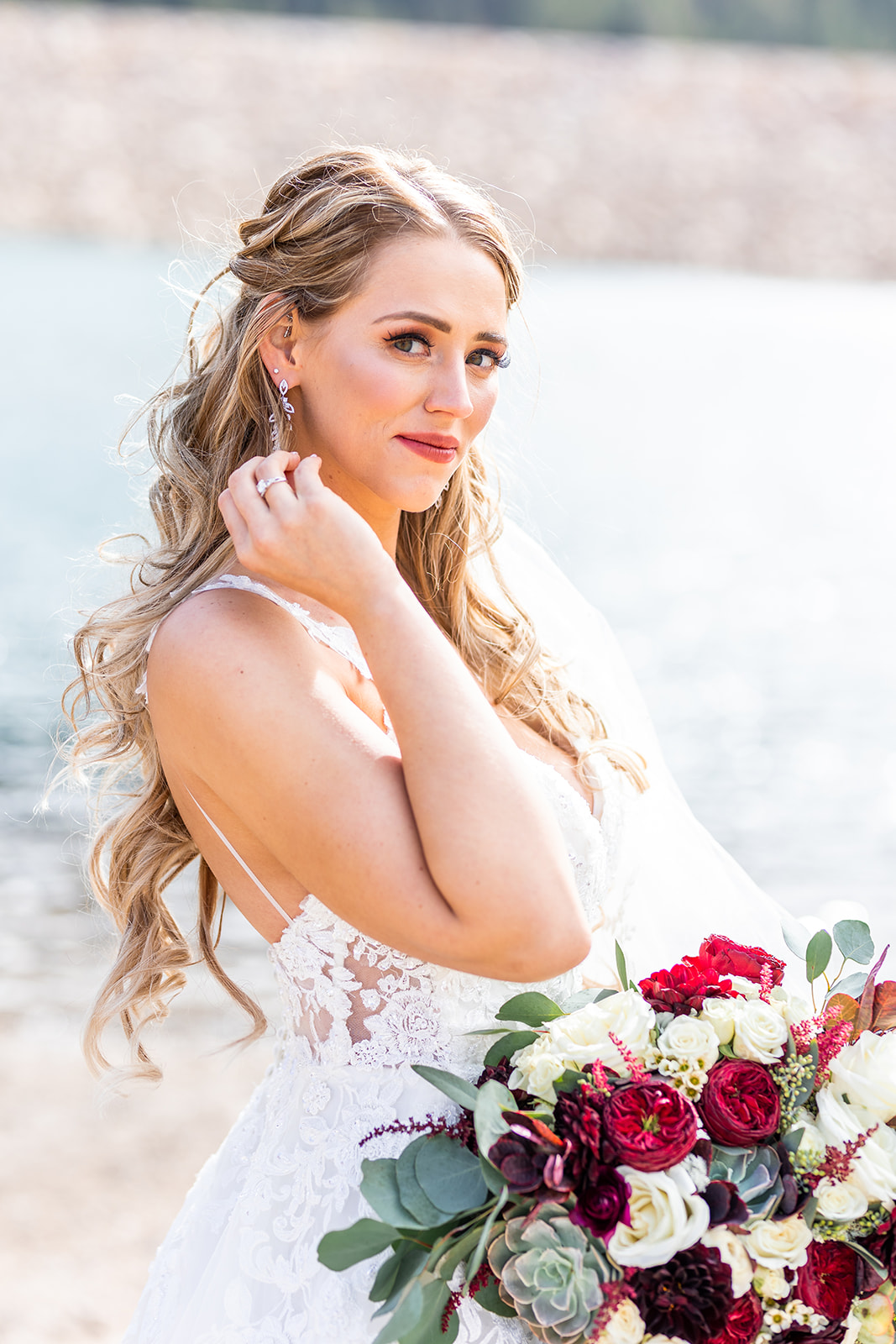 bride on river banks with bouquet